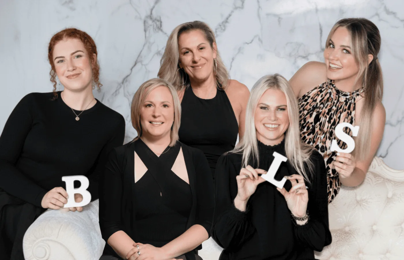 Beauty Lounge St Kilda team on the marble and cream chaise set